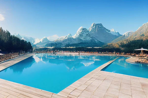 Outdoor swimming pool at the resort, Mountains landscape panorama, Snow on the tops of the mountain range