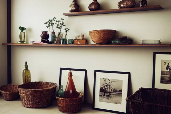 home interior decoration the branches in vintage bottles and baskets on white shelves