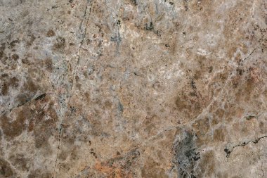 Kaya dokusu. Taş zemin. Çatlak arka planda yıpranmış eski bir dağ yüzeyi. Açık kahverengi kaya arkaplanı.