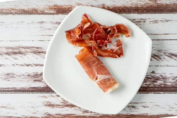 Top View Exquisite Spanish Serrano Ham White Plate — стокове фото