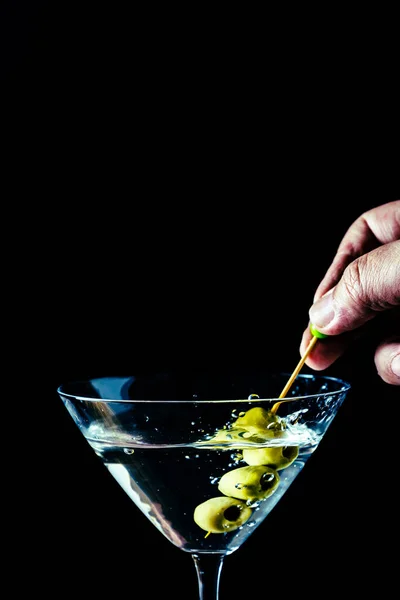 Hand Pouring Some Olives Martini Glass Vertical Orientation Copyspace — Stock Photo, Image