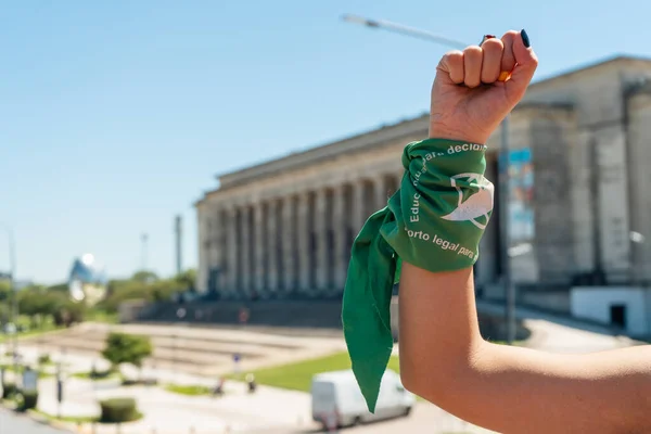 Fist with a green scarf symbolizing the feminist struggle for equality and legal abortion in Latin America. Legal, safe and free abortion. Concept of feminism, health, equality.