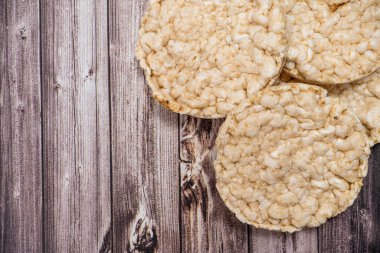A Round rice crackers on a rustic wooden table. Copy space. Healthy, natural food. Vegan food. Top view