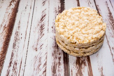 A Round rice crackers on a rustic wooden table. Copy space. Healthy, natural food. Vegan food. High view