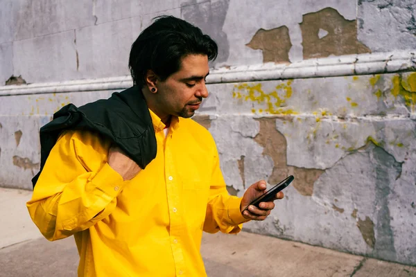 Young Latino Man Checking Messages His Cell Phone Walks Street — Stock Fotó