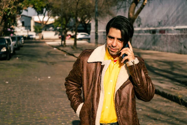 Portrait Handsome Young Latino Man Leather Jacket Talking Phone Street — Stock Fotó