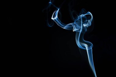 Abstract shape of colored Smoke on a black background. copy space.