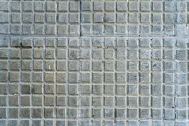 A Background of square tiles or slabs on a wall.