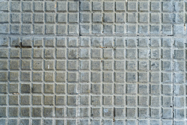 A Background of square tiles or slabs on a wall.