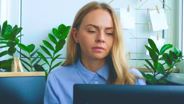 Trabajadora caucásica joven y somnolienta cansada en el lugar de trabajo. Sobretrabajo y privación del sueño. Empresaria y crisis monetaria. Freelancer en depresión. Mujer triste mirando un portátil — Vídeo de stock