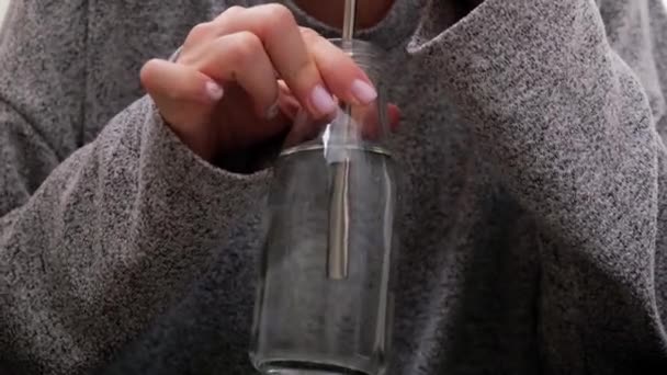 Joven mujer rubia milenaria bebiendo agua de eco botella con tubo de paja reutilizable de metal y haciendo ejercicio de yoga estirando fitness en el balcón de casa. Meditación de atención plena. El concepto de saludable — Vídeos de Stock