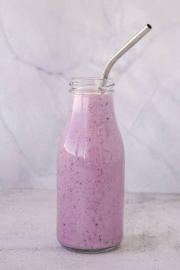 Yabanmersinli böğürtlen püresi. Bir bardak kahvaltılık protein içeceği püre yaban mersini, muz, süt, yoğurt ve süzme peynirden yapılır. Vejetaryen yemeği.