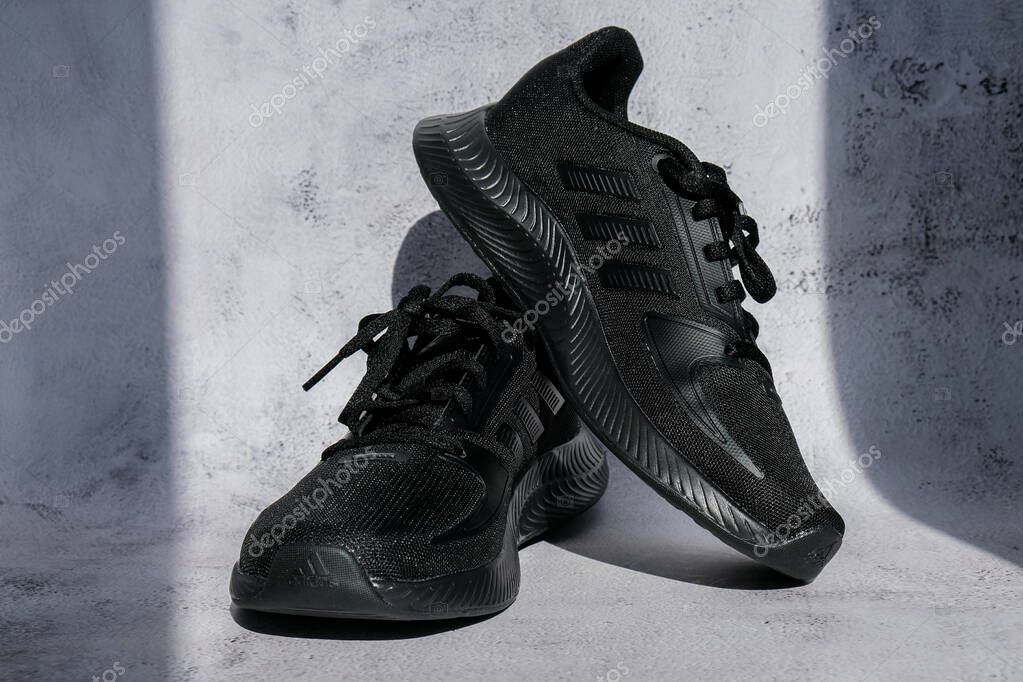 Kiev Ukraine - October 2021 Black Adidas Running boots. Multinational company. Product shots. Adidas swift run shoes for running for woman - illustrative editorial. Unisex for women and men