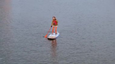 Gdansk Polonya Mart 2022 Sup sörfçüleri grubu ayağa kalkar, kadınlar eski şehir Gdansk Polonya 'da Motlawa nehri ve kanalında birlikte kürek çekerler. Turizm eğlencesi Aktif açık hava