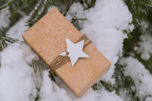 圣诞生态礼物的乡村老式风格 寒假是在白雪覆盖的冷杉枝干的衬托下进行的 零废物 无塑料 用棕色自然再生牛皮纸手工制作的老式礼品盒 没有环保塑料工艺理念 — 图库照片