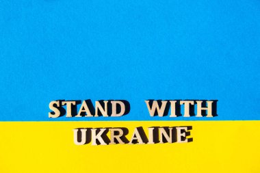 Kağıttan yapılmış Ukrayna ulusal bayrağı. Ukraine metni ile ayakta dur. Savaşı durdurun. Ukrayna 'daki savaşı bitirme kavramı. Ukrayna halkının ulusal sembolü - mavi ve sarı. Rus işgaline karşı savaş protestosu. pankart boyutu
