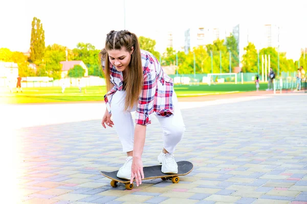 スケートボードに座っている若い千年紀の女性ヒッピー。夏のスケートセッション。公園のロングボードを巡航する女性。フリースケーター20代女性｜ユースライフスタイルを楽しむ — ストック写真