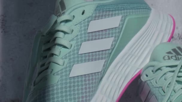 Kiev Ucraina - ottobre 2021 Nuovi stivali da corsa moderni alla moda Adidas Blu e Rosa. Colpi di prodotto. Adidas scarpe da corsa veloci per correre per donna - editoriale illustrativo — Video Stock