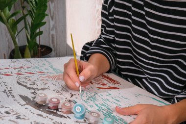 Kadın elleri tuvali boyuyor. Yaratıcı bir hobi. Yeni başlayanlar için resim yapmak. Evde kilitli kalmak için boş zaman aktivitesi, stres önleyici bir fikir. Meditasyon, rahatlama konsepti. Farkındalık canlılık