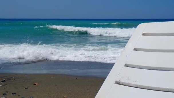 Sun loungers by the sea waves. Free Empty beaches during quarantine. Summertime vacation holiday — Stockvideo