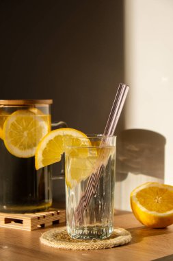 Glass of water with fresh lemon juice with Reusable glass Straws Detox cold tonic water with sunny lemon slices Low-waste lifestyle Eco-Friendly Drinking Straw 