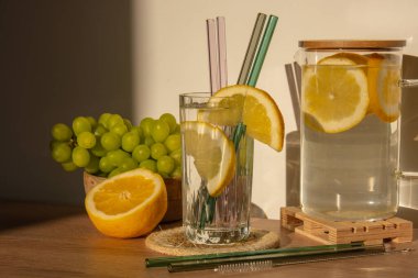 Glass of water with fresh lemon juice with Reusable glass Straws Detox cold tonic water with sunny lemon slices Low-waste lifestyle Eco-Friendly Drinking Straw 