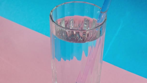 Drinking water from Reusable glass Straws on blue background Eco-Friendly Drinking Straw Set with cleaning brush. Zero waste, plastic free concept — Vídeo de Stock