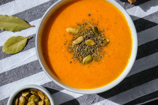 Homemade carrot ginger curcuma soup. Seasonal Pumpkin traditional soup with creamy silky texture. Healthy vegan clean eating. Seasonal spicy fall vegetables creamy pumpkin and carrot soup Prevention of antiviral infections