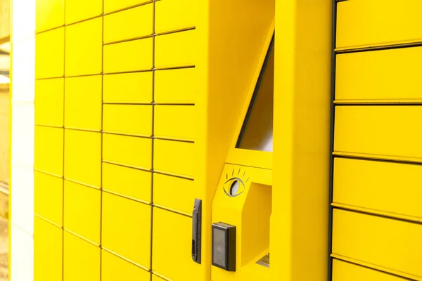 Modern yellow shopping locker. Bar code reader for Skans QR Code on Mobile phone Self-service Locker Cell Modern Shipping and Delivery Concept with Contactless Automated Postal Box. Parcel Locker