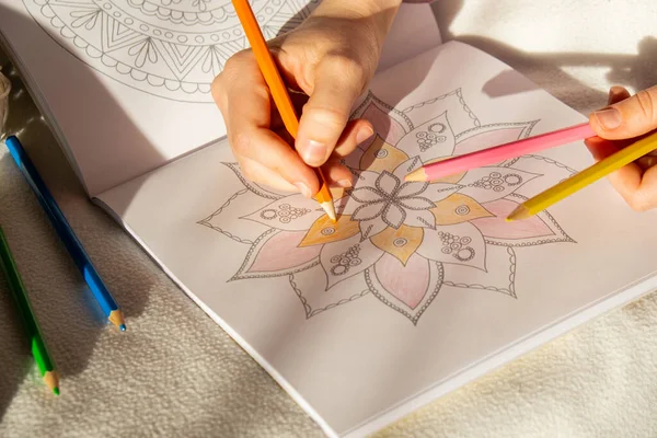 stock image Woman coloring antistress page. Female hand painting mandala. Female painting mandalas to combat stress. Relaxing hobby mental wellbeing and art therapy. Woman paints sketch, meditative process of