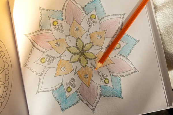 Coloring antistress page. Painting mandala to combat stress. Relaxing hobby mental wellbeing and art therapy. Sketch, meditative process of coloring pages. Self expression by art