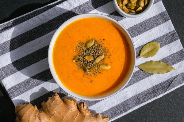 Homemade carrot ginger curcuma soup. Seasonal Pumpkin traditional soup with creamy silky texture. Healthy vegan clean eating. Seasonal spicy fall vegetables creamy pumpkin and carrot soup Prevention of antiviral infections