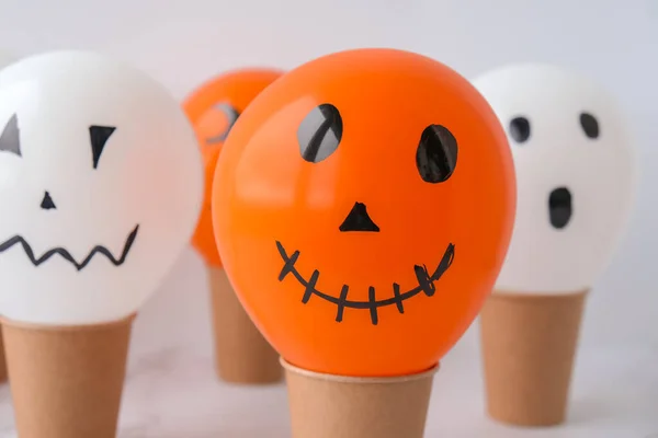 Painted Jacks face on balloons. Orange and white balls preparation diy for halloween party. Halloween home activities. Handmade toys Children craft