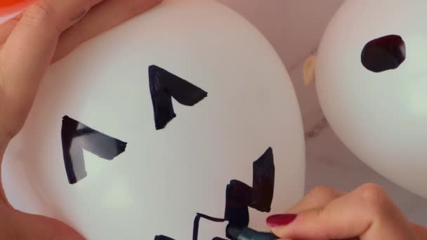 Female Hands Painting Jacks Face Balloons Orange White Balls Preparation — Video Stock