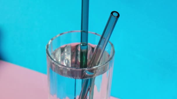 Put Reusable Glass Straws Glass Water Blue Background Eco Friendly — Stock Video