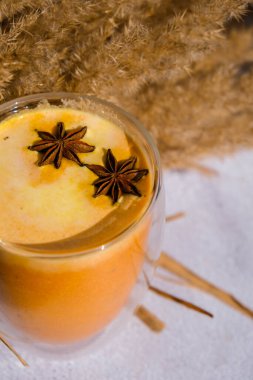 Balkabaklı, baharatlı latte. Anason yıldızları. Baharatlı balkabağı aromalı sonbahar kahvesi mevsimlik sıcak içecek. Cadılar Bayramı ve Şükran Günü için sonbahar içkileri. Vejetaryen sağlıklı diyet yemekleri