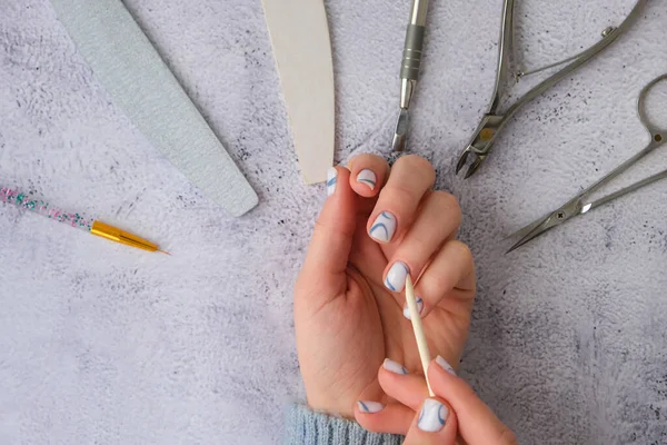 Professional stylish trendy blue Hardware Manicure. Procedure for the preparation of nails. Cuticle Pusher Remover. Nail file scissors Top view flat lay. Do manicure by yourself staying at home. Self care. Spa, beautician advertisement.