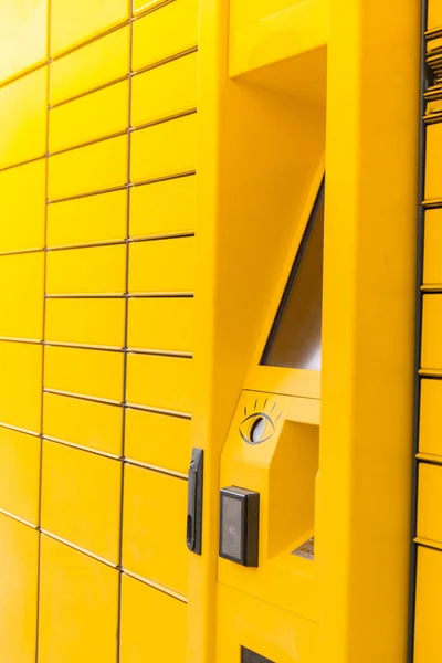 Modern yellow shopping locker. Bar code reader for Skans QR Code on Mobile phone Self-service Locker Cell Modern Shipping and Delivery Concept with Contactless Automated Postal Box. Parcel Locker