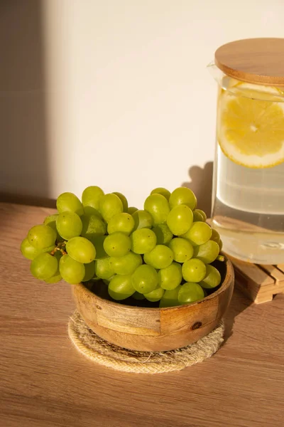 Green Grapes lie on eco dish. Eco-friendly choice and friendly nature. The concept of world without plastic free and clean planet. Eco-friendly tableware made of natural materials