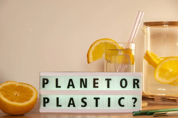 Lightbox with text PLASTIC OR PLANET Glass of water with fresh lemon juice with Reusable glass Straws Detox cold tonic water with sunny lemon slices Low-waste lifestyle Eco-Friendly Drinking Straw Set