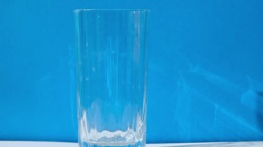 Adding water to glass on blue background Eco-Friendly Drinking Straw Set with cleaning brush. Zero waste, plastic free concept. Sustainable lifestyle. Waste free living Low waste 