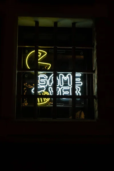 Game over inscription in neon lights at night. Electric sign at night nightlife concept. Modern fluorescent life style luminescent. LED light sign text color lighting