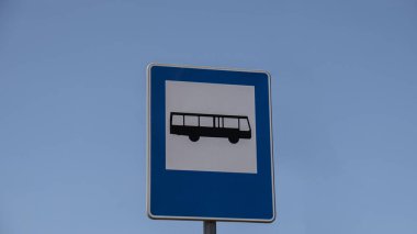 Blue and white bus stop sign in Europe with sky background. Bus stop old road sign Copy space