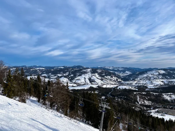 Ski Lift snowy mountain winter forest with chair lift At The Ski Resort in winter. Snowy weather Ski holidays Winter sport and outdoor activities Outdoor tourism skiing snowboarding