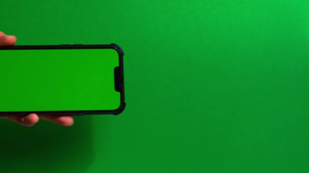 Manos Sosteniendo Teléfono Celular Con Pantalla Verde Sobre Fondo Verde — Vídeo de stock