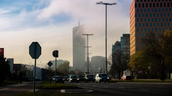 Clouds cover city sky tower skyscraper Public transport scene in Gdansk. Oliva business district Transport city traffic. Trams buses cars City Traffic Jam. City life