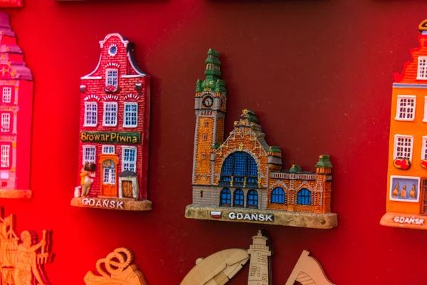 Rows of fridge magnet souvenirs from Gdansk displayed on stillage. Model houses magnets on display in Gdansk Poland travel destination concept in city market square