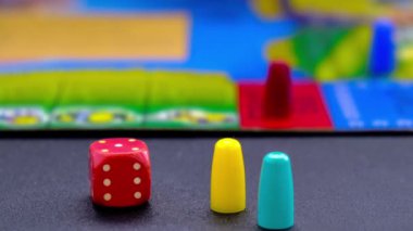 Dice 'ı siyah arkaplandaki masa oyunları için yakınlaştır. Masa oyununda çok renkli küplerle masa oyunu. Çocuklar için ev eğlencesi oyunları
