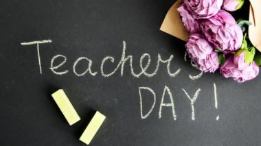 4k yakınlaştır, düz kompozisyonda çiçek şakayıkları buketi ve siyah karatahtaya yazılı öğretmenler günü yatıyordu. Okula dönelim. Okul tatili