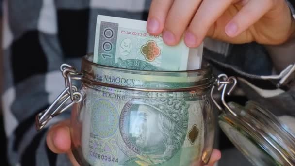 Polish Zloty Banknote Saving Money Glass Jar Unrecognizable Woman Moderate — стоковое видео